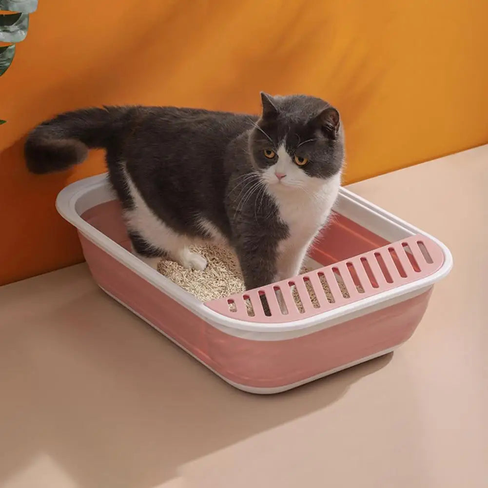 front image of pink color large capacity cat litter box with cat standing inside the box