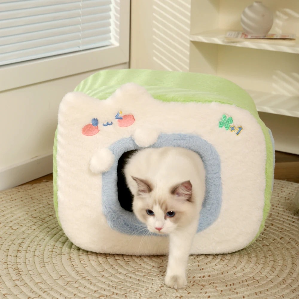 front image of green color Cubic Warm Cat House with cat exiting from the house