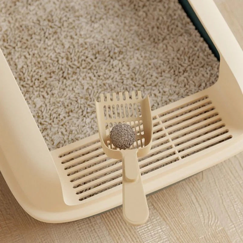 Semi-Enclosed Cat Litter Box Close Up Image Showing Shovel Scooping the Sand