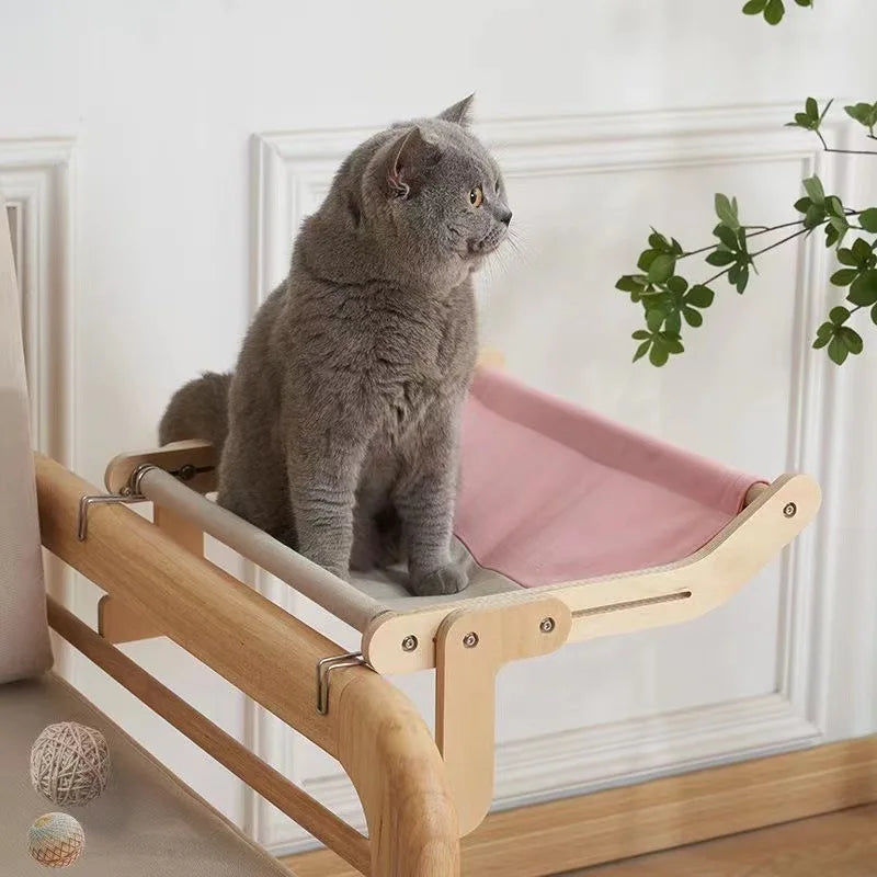 side image of cat sitting on Sturdy Wooden Hanging Cat Bed