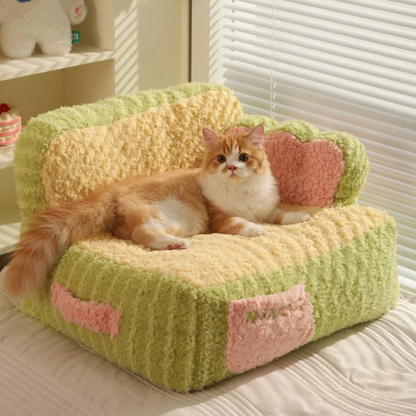 front image of green color Cake Sofa Cat Bed with cat lying on it