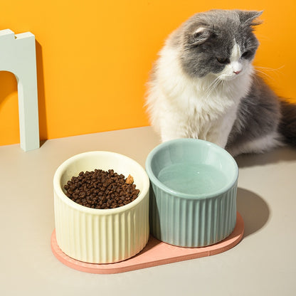 Two Ceramic Striped Pet Bowls Top Image with Cat Sitting Behind